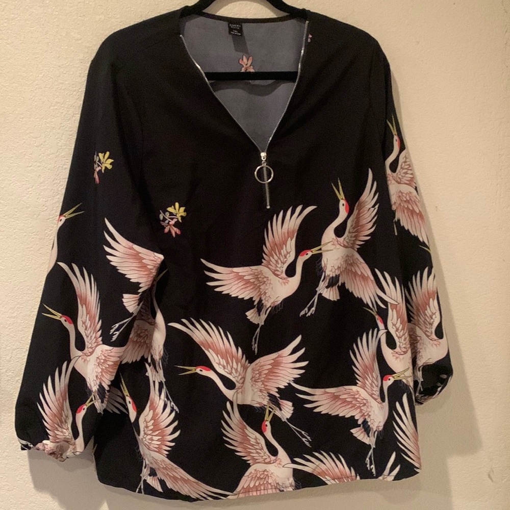 Women’s plus size crane blouse with zipper neck line.